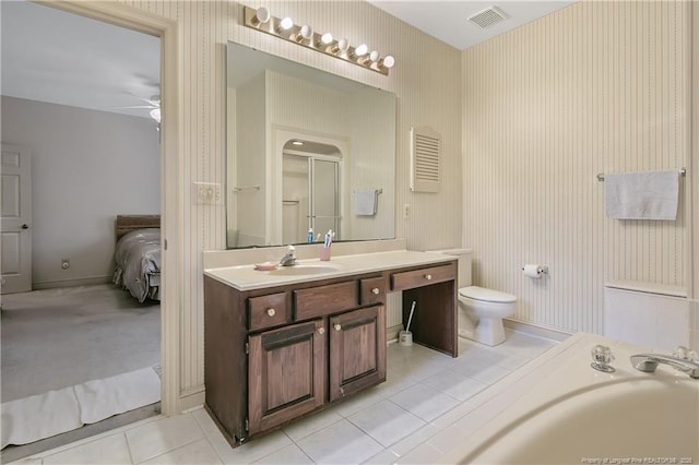 bathroom with ceiling fan, vanity, a bath, tile patterned floors, and toilet