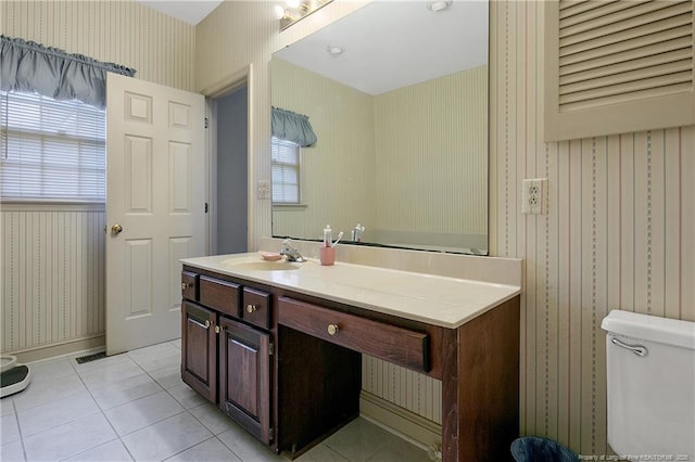 bathroom featuring tile patterned floors, toilet, vanity, and plenty of natural light