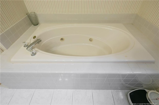 bathroom featuring a relaxing tiled tub and tile patterned floors