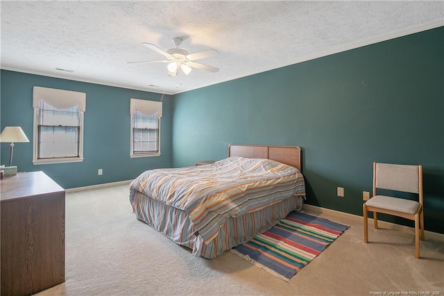 bedroom featuring crown molding, light colored carpet, ceiling fan, and a textured ceiling