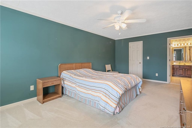 bedroom with crown molding, light carpet, ceiling fan, and ensuite bathroom