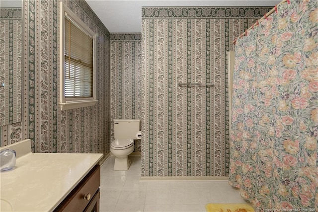 bathroom featuring vanity, toilet, and tile patterned flooring