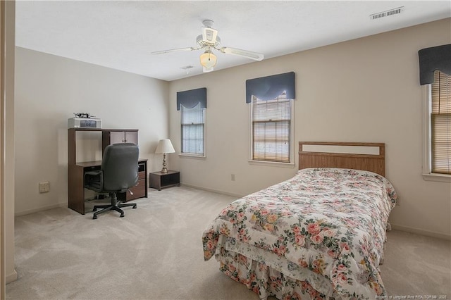 bedroom featuring ceiling fan and light carpet