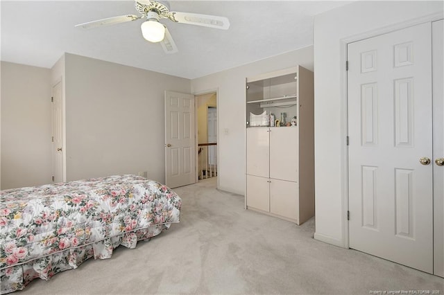 carpeted bedroom with ceiling fan