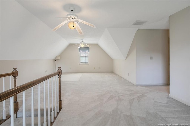 additional living space featuring ceiling fan, vaulted ceiling, and light carpet