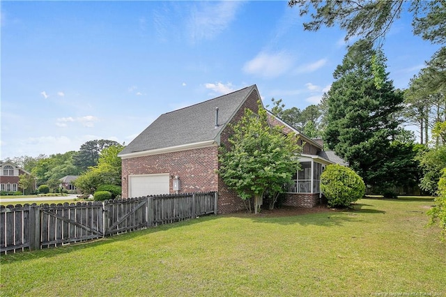 view of side of home featuring a garage and a lawn