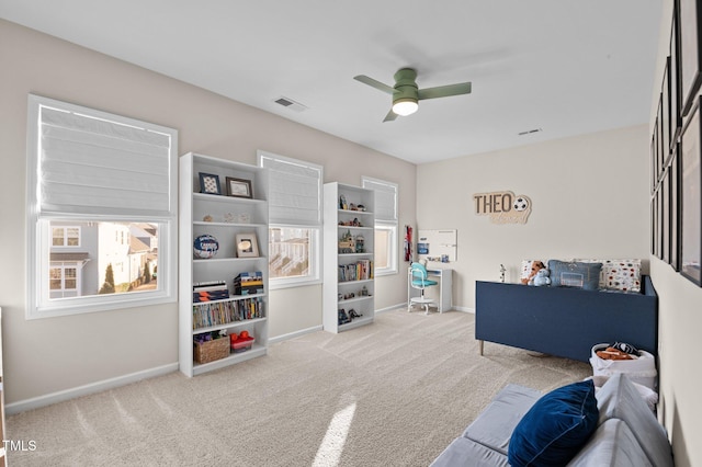 interior space featuring light carpet and ceiling fan