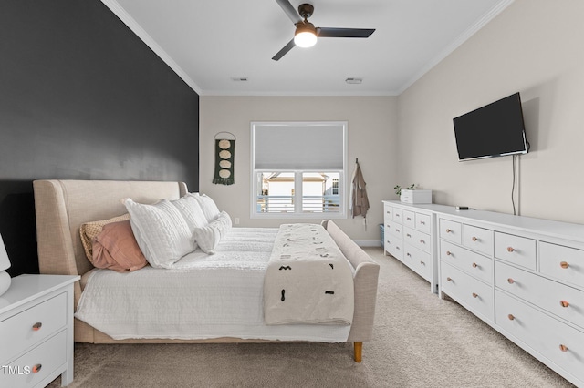 bedroom with ceiling fan, ornamental molding, and light carpet