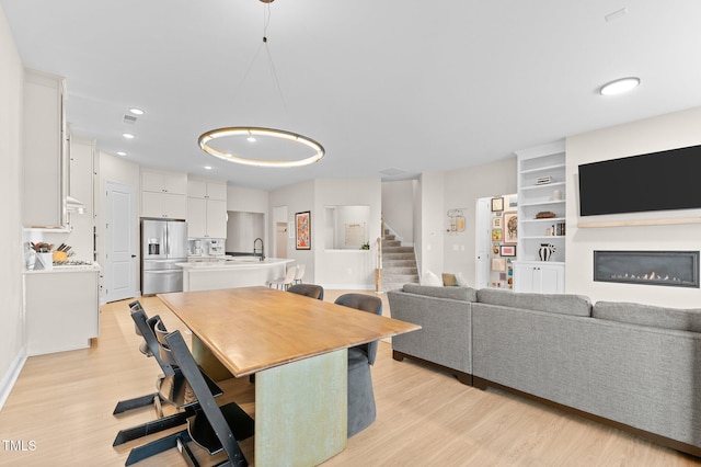 dining space featuring sink and light hardwood / wood-style flooring