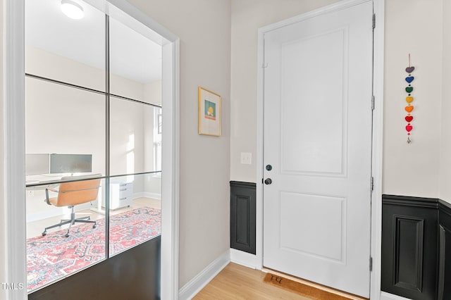 foyer entrance with light hardwood / wood-style flooring