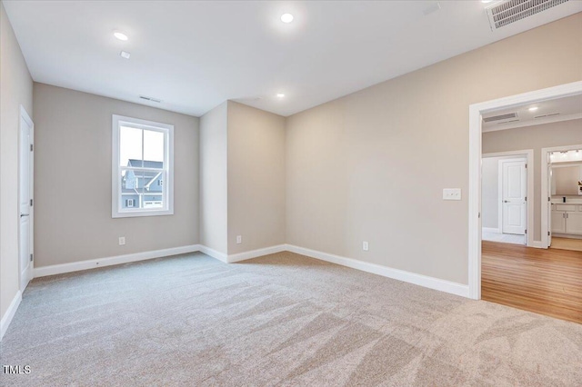 unfurnished room with light carpet