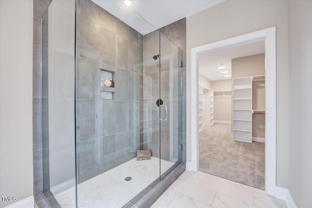 bathroom featuring a shower with shower door