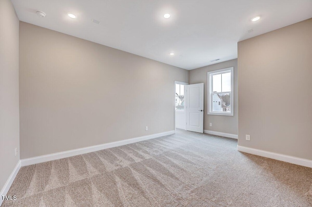 unfurnished room featuring light colored carpet