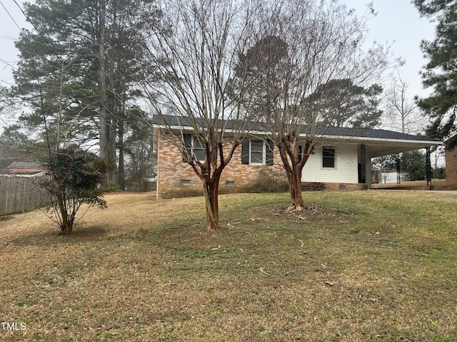 view of front facade featuring brick siding, a front lawn, crawl space, and an attached carport