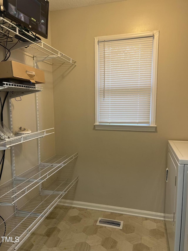 spacious closet with washer / dryer and visible vents