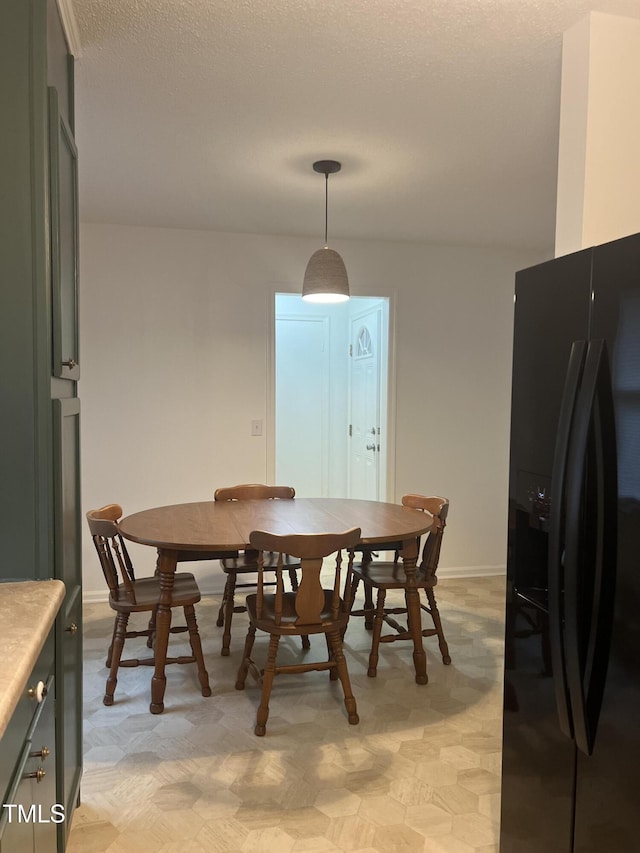 dining space featuring baseboards