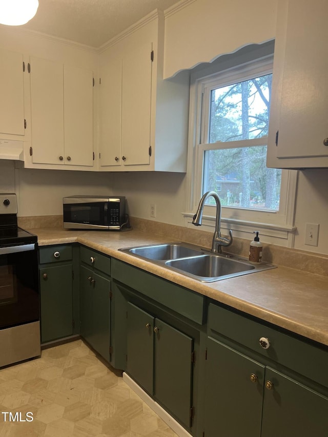 kitchen featuring white cabinets, appliances with stainless steel finishes, ventilation hood, and a sink