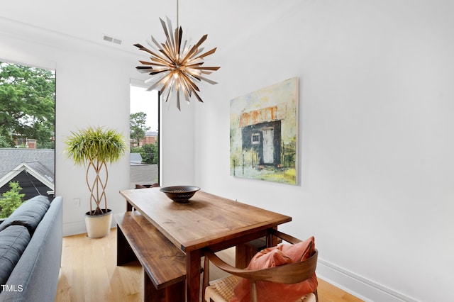 dining area featuring a notable chandelier, plenty of natural light, and light hardwood / wood-style floors