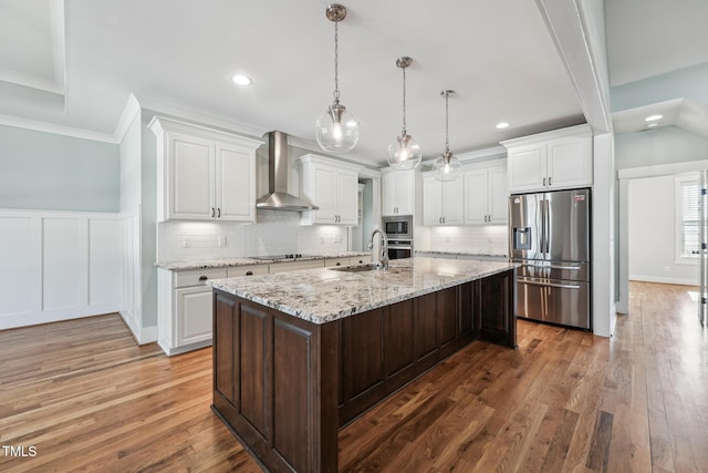 kitchen featuring wall chimney exhaust hood, appliances with stainless steel finishes, and white cabinets