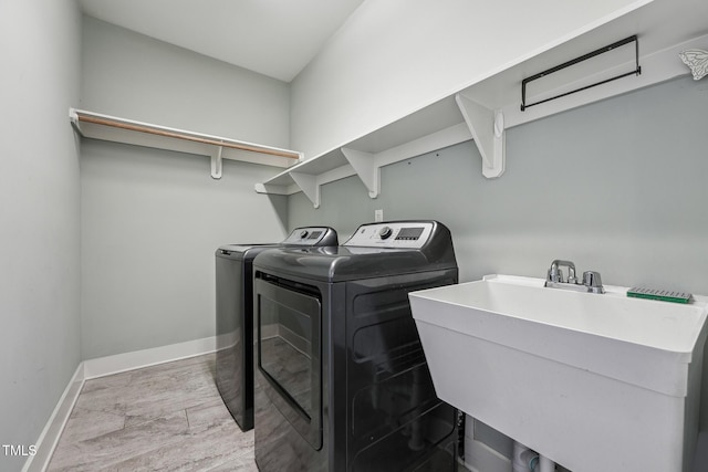 laundry room featuring independent washer and dryer and sink