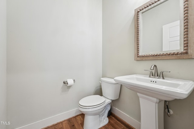 bathroom with hardwood / wood-style floors and toilet