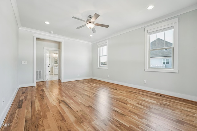 spare room with ornamental molding, ceiling fan, and light wood-type flooring