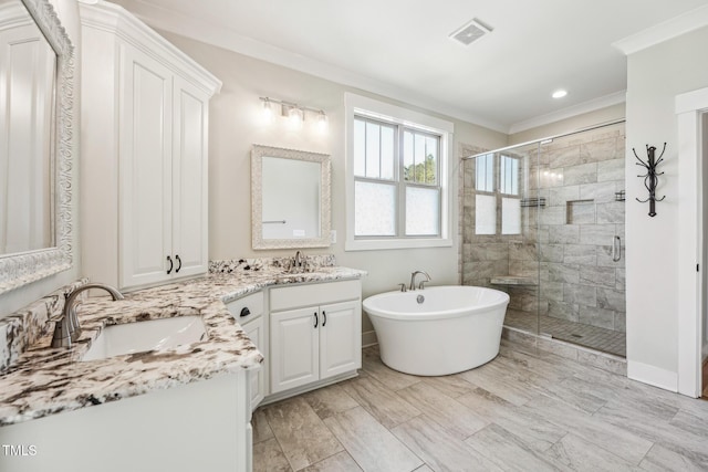 bathroom with vanity, ornamental molding, and separate shower and tub