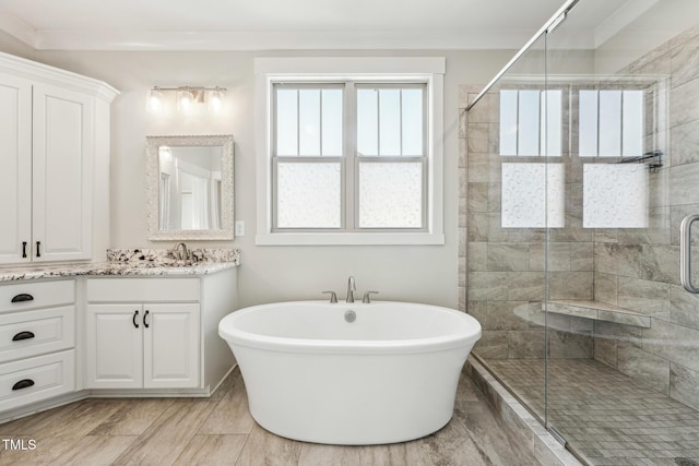 bathroom featuring plus walk in shower and vanity