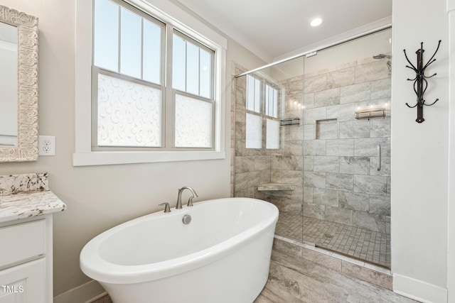 bathroom with vanity and separate shower and tub