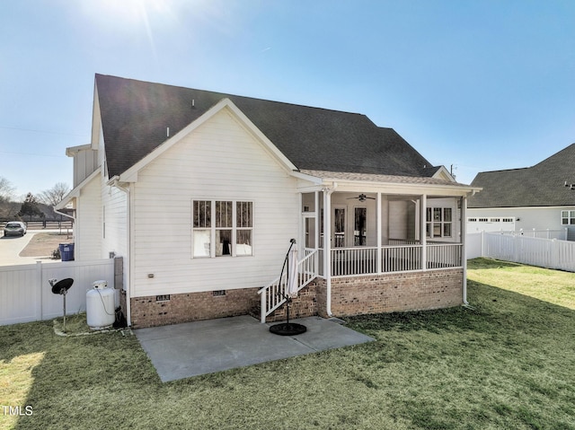 back of house with ceiling fan, a patio, and a lawn