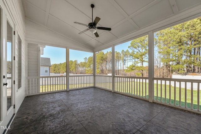 unfurnished sunroom featuring ceiling fan and vaulted ceiling