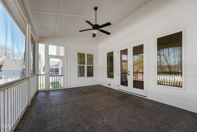 unfurnished sunroom featuring plenty of natural light, lofted ceiling, and ceiling fan