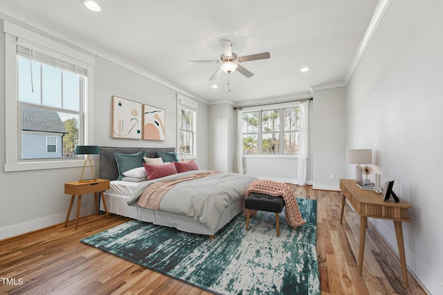 bedroom featuring hardwood / wood-style flooring, crown molding, and ceiling fan