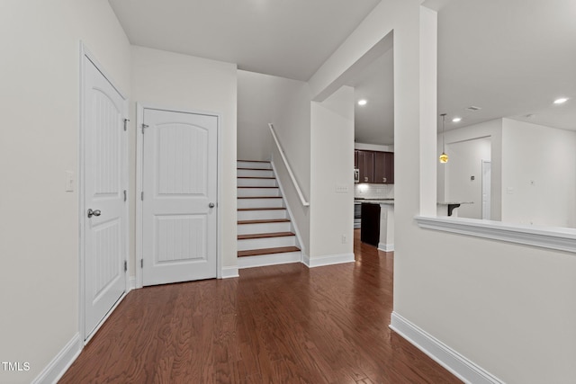 entrance foyer with baseboards, stairway, dark wood-type flooring, and recessed lighting