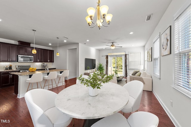 dining space with baseboards, visible vents, dark wood-style flooring, and recessed lighting