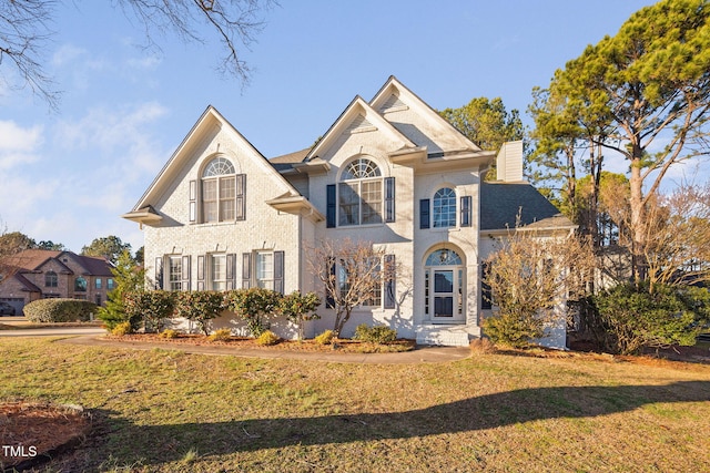 view of front of property with a front lawn and a chimney