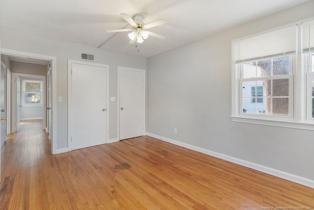 unfurnished bedroom with wood-type flooring and ceiling fan