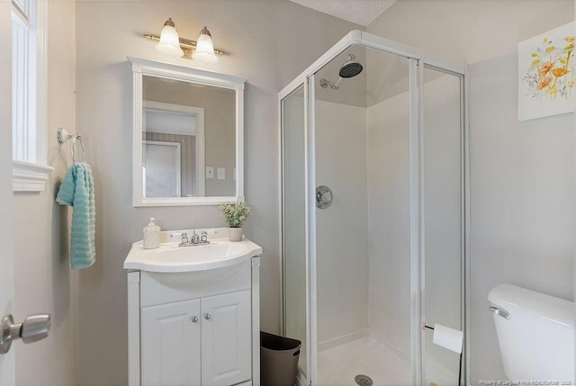 bathroom with vanity, toilet, and walk in shower