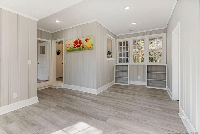 interior space featuring crown molding and light wood-type flooring