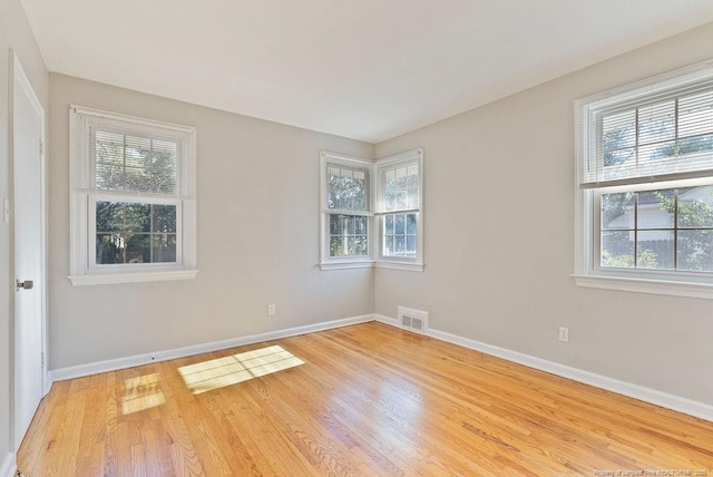 empty room with light hardwood / wood-style floors