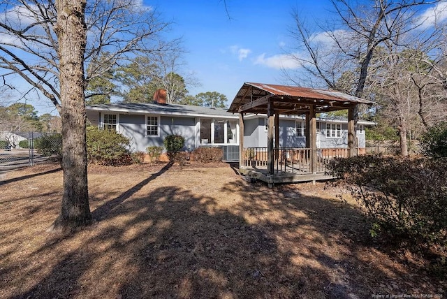 back of house featuring a gazebo