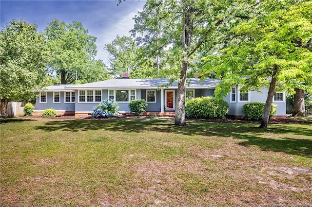 ranch-style home with a front lawn