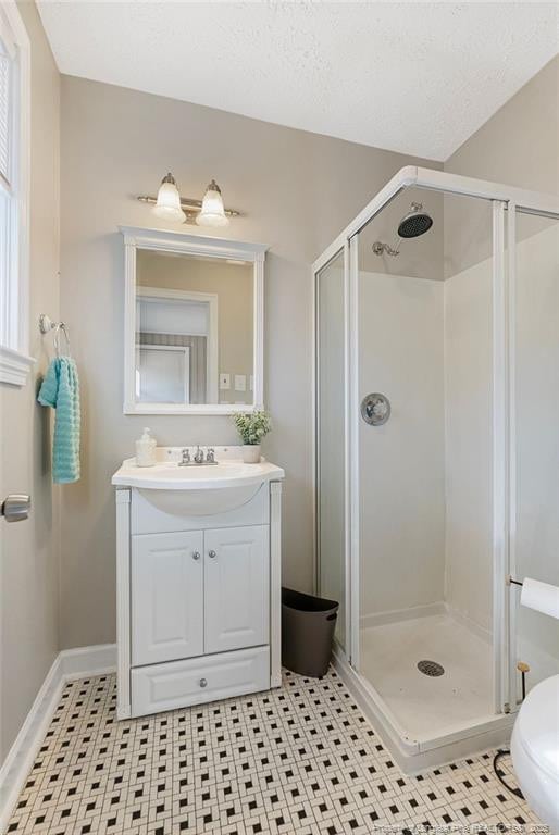 509 Vista Dr, Fayetteville, NC 28305 - bathroom with a stall shower, vanity, and baseboards