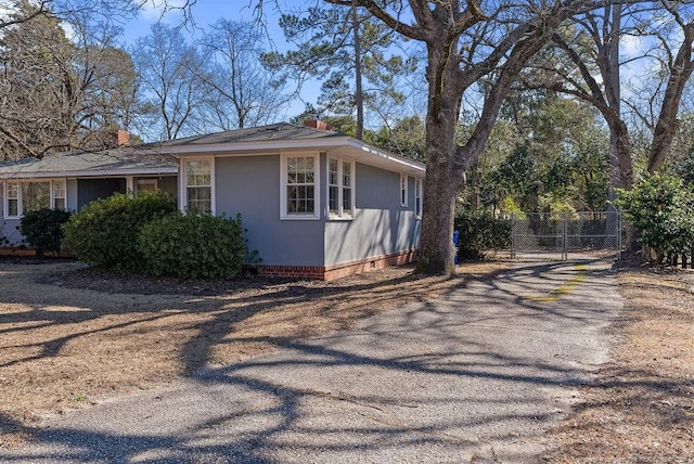 509 Vista Dr, Fayetteville, NC 28305 - view of side of property featuring fence, asphalt driveway, a chimney, and crawl space