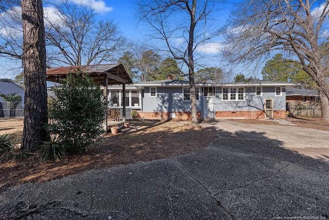 509 Vista Dr, Fayetteville, NC 28305 - view of front of home with crawl space, asphalt driveway, and a chimney