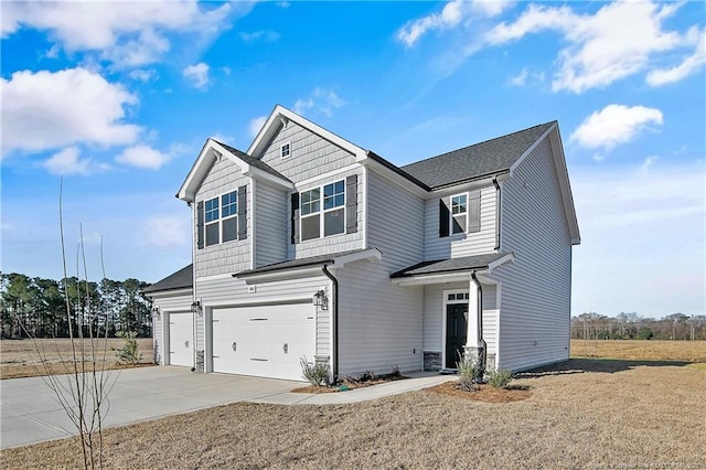 view of front of property featuring a garage, driveway, and a front lawn