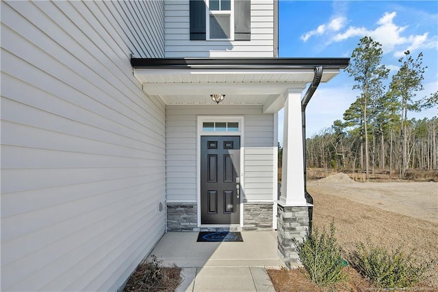 doorway to property featuring stone siding