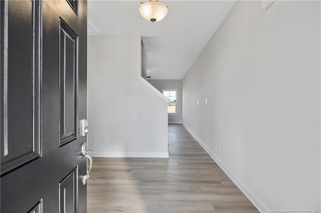 entrance foyer with light wood-type flooring and baseboards