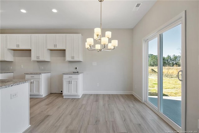 kitchen with plenty of natural light and white cabinets