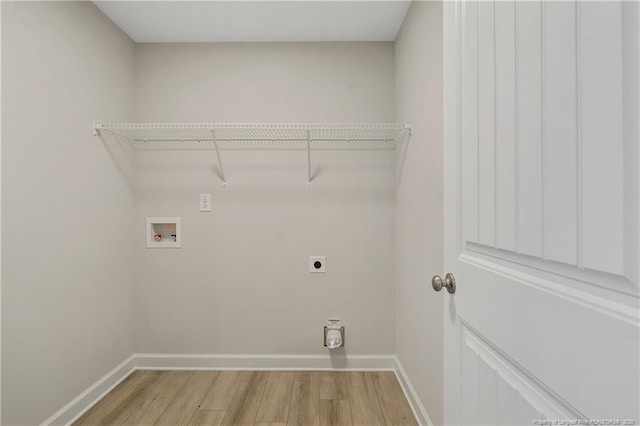 washroom with light wood finished floors, hookup for a washing machine, electric dryer hookup, laundry area, and baseboards